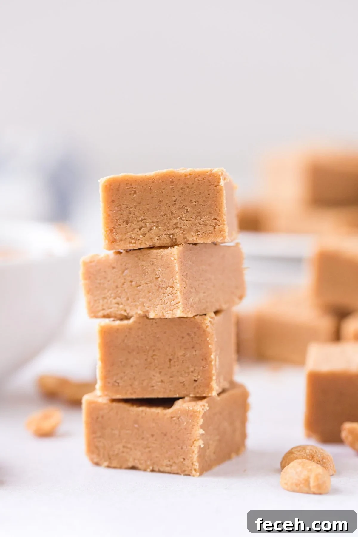 Creamy Peanut Butter Fudge Recipe for Rich, No-Bake Treats 7 Easy Peanut Butter Fudge stacked on top of each other.
