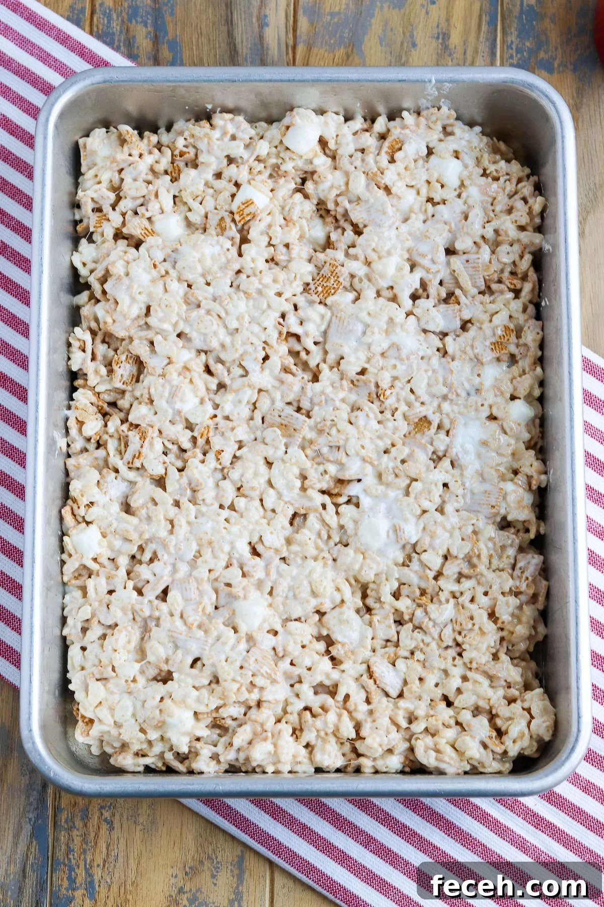 Golden Graham Rice Krispie Treats Recipe — Crispy Marshmallow Squares 4 9 x 13 cake pan of hot golden graham Rice Krispie treats