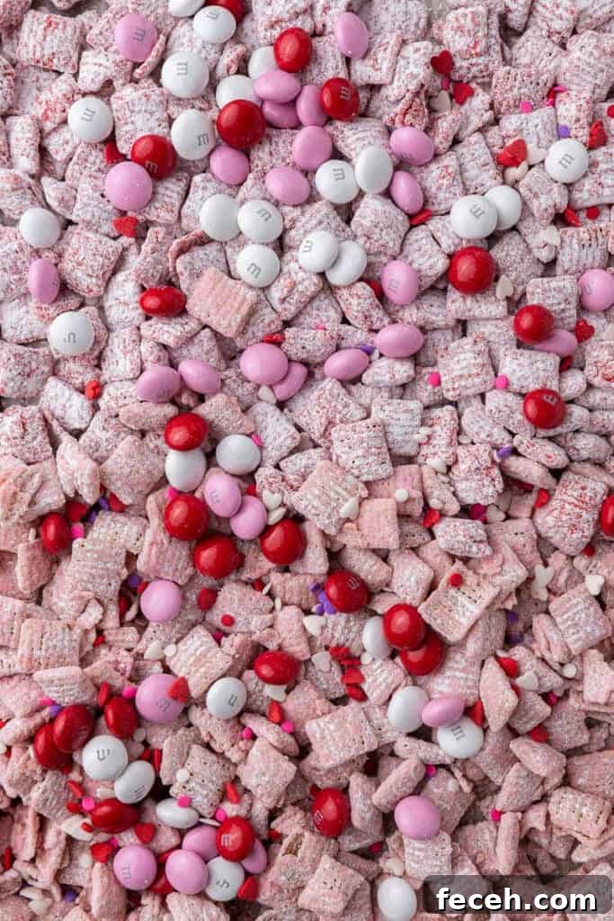 Valentine's day puppy chow Pink muddy buddies on baking sheet