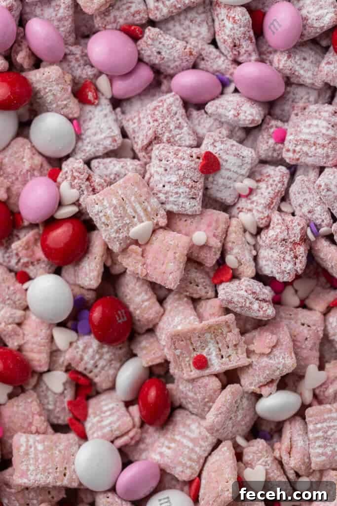 Close-up of Valentine’s muddy buddies with powdered sugar and candy mix-ins