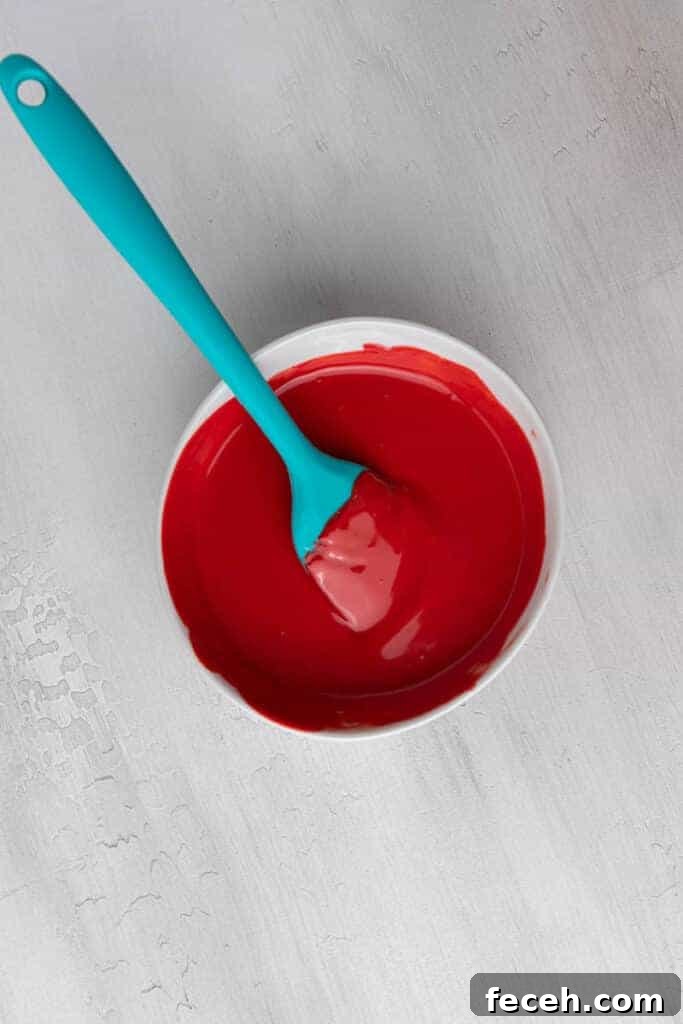 Red candy in a bowl with a spatula in there