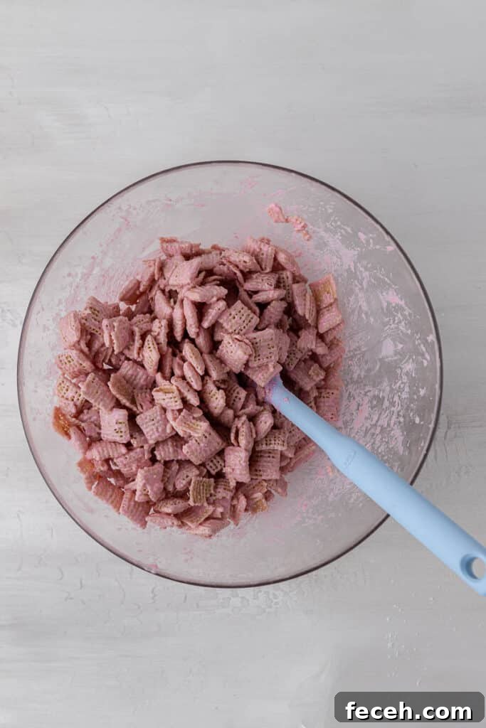 Chex cereal coated in pink candy melts for Valentine’s Day muddy buddies