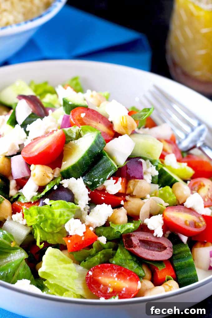 Crisp Chopped Greek Salad with Feta and Lemon Dressing 2 Crisp Chopped Greek Salad with Kalamata olives and Feta cheese on a white bowl.