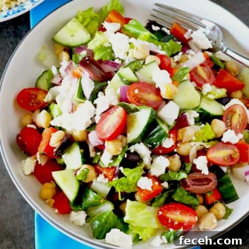 Crisp Chopped Greek Salad with Feta and Lemon Dressing 5 Crisp Chopped Greek Salad with Kalamata olives and Feta cheese on a white bowl.