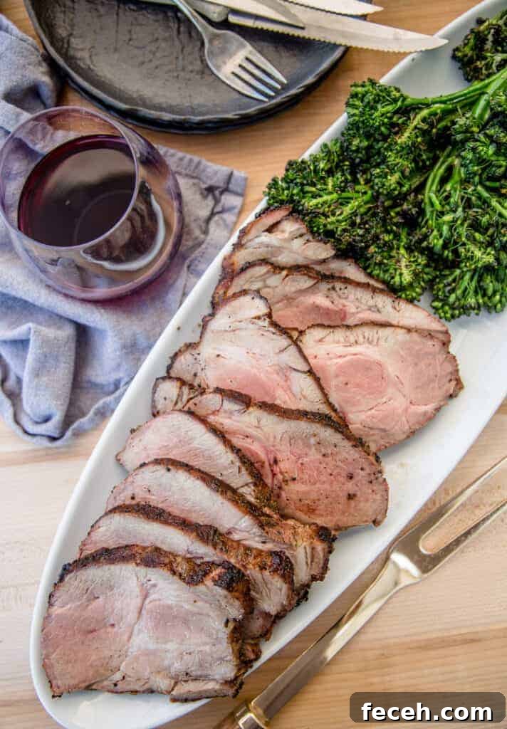 Citrus-Marinated Grilled Pork Collar Recipe for Juicy Flavor 2 Grilled pork collar cut into slices with grilled broccolini and a glass of red wine
