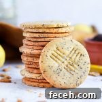 One cookie leaning on a stack of shortbread