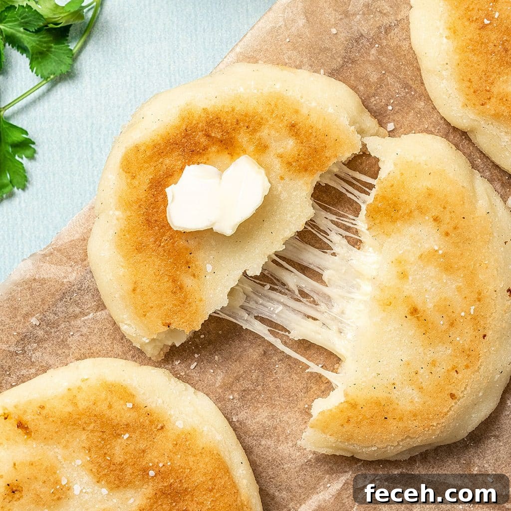 Cook Once, Eat Twice: Budget Meals That Become Delicious Leftovers 10 top view of an arepa cut in half with melted cheese inside