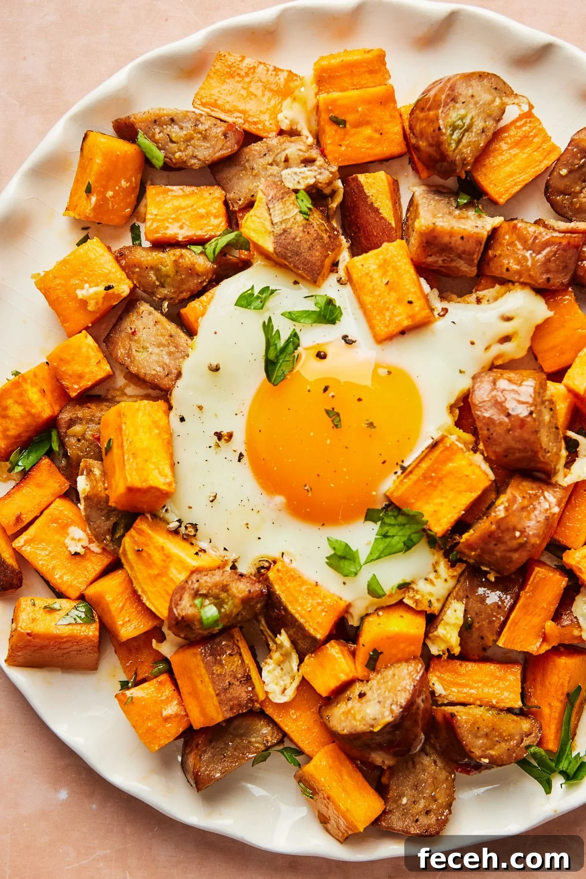 Plated breakfast bowl with sweet potato hash and eggs