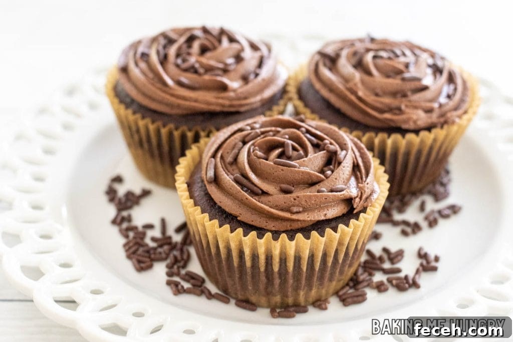 small batch chocolate frosting shown on 3 chocolate cupcakes on a white plate