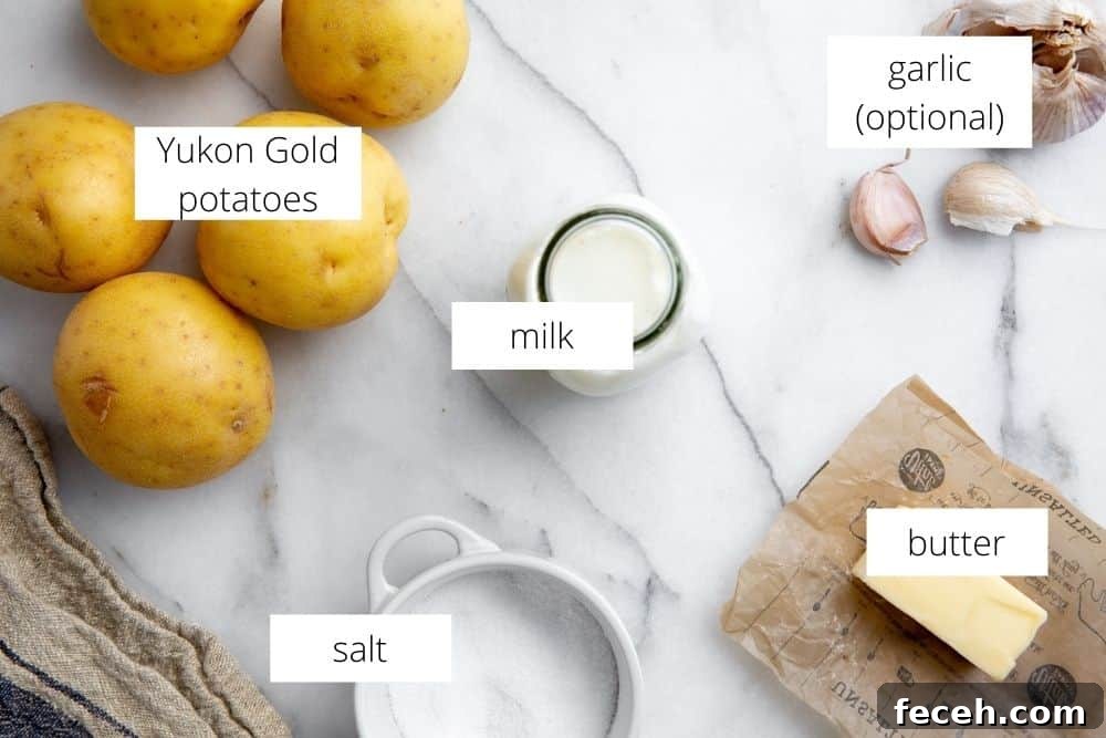 All of the ingredients for the pomme puree recipe arranged on a marble surface with labels.