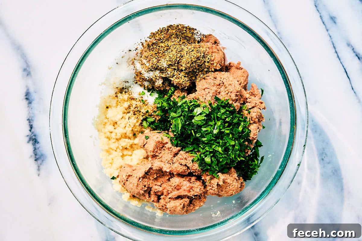 Vegan Italian Wedding Soup Recipe with Plant-Based Meatballs 7 Plant based sausage in a bowl with breadcrumbs, parsley, and herbs for vegan meatballs.