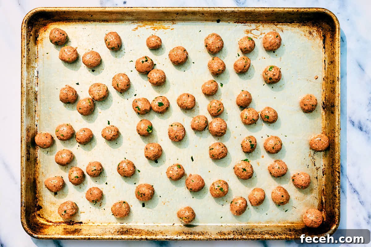 Vegan Italian Wedding Soup Recipe with Plant-Based Meatballs 8 Vegan mini meatballs on a baking sheet before getting baked in the oven.