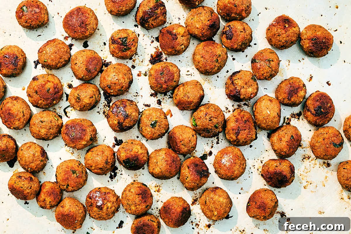 Vegan Italian Wedding Soup Recipe with Plant-Based Meatballs 9 Crispy vegan meatballs on a sheet pan after baking.