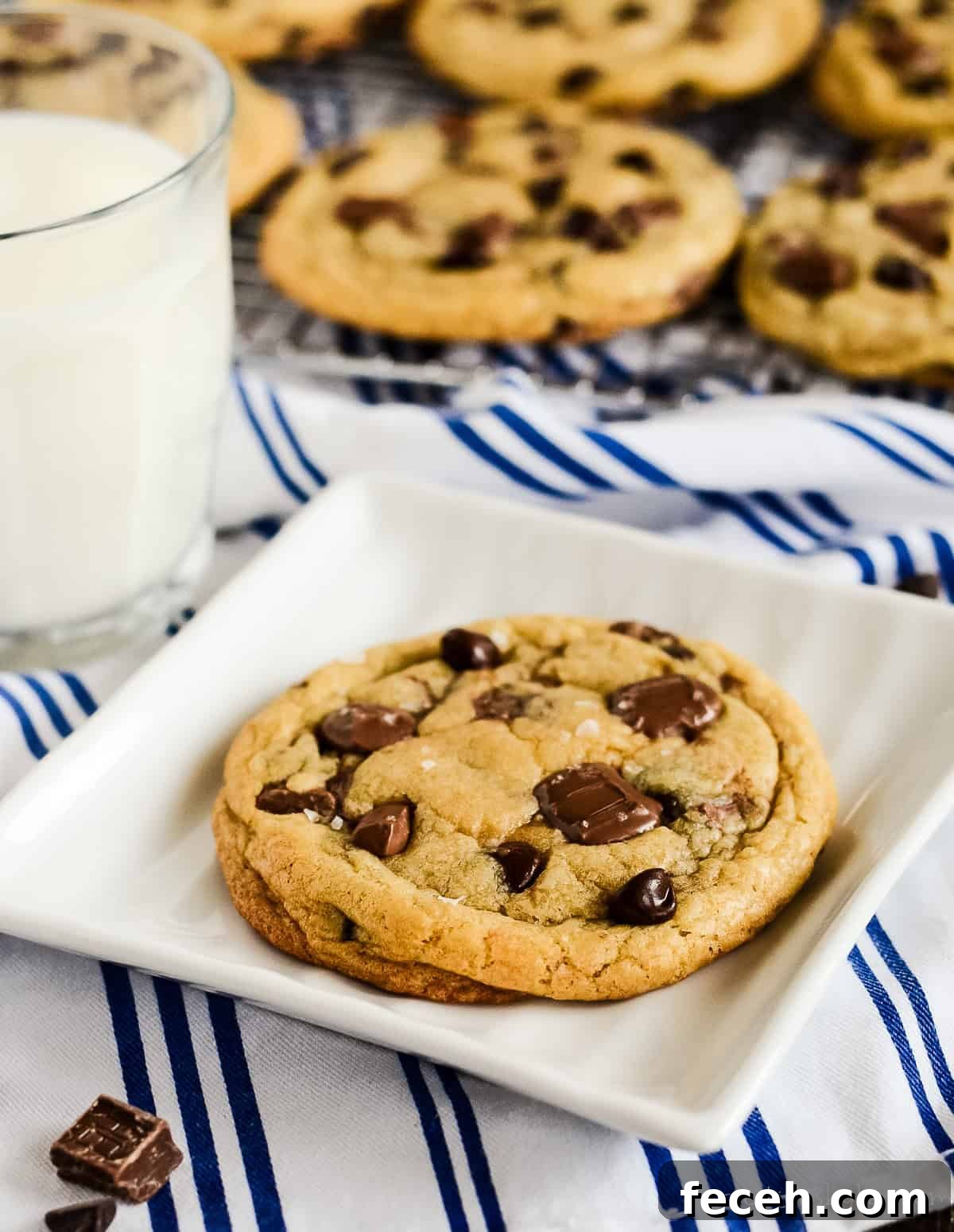 copycat starbucks chocolate chip cookie on a white plate with a glass of milk