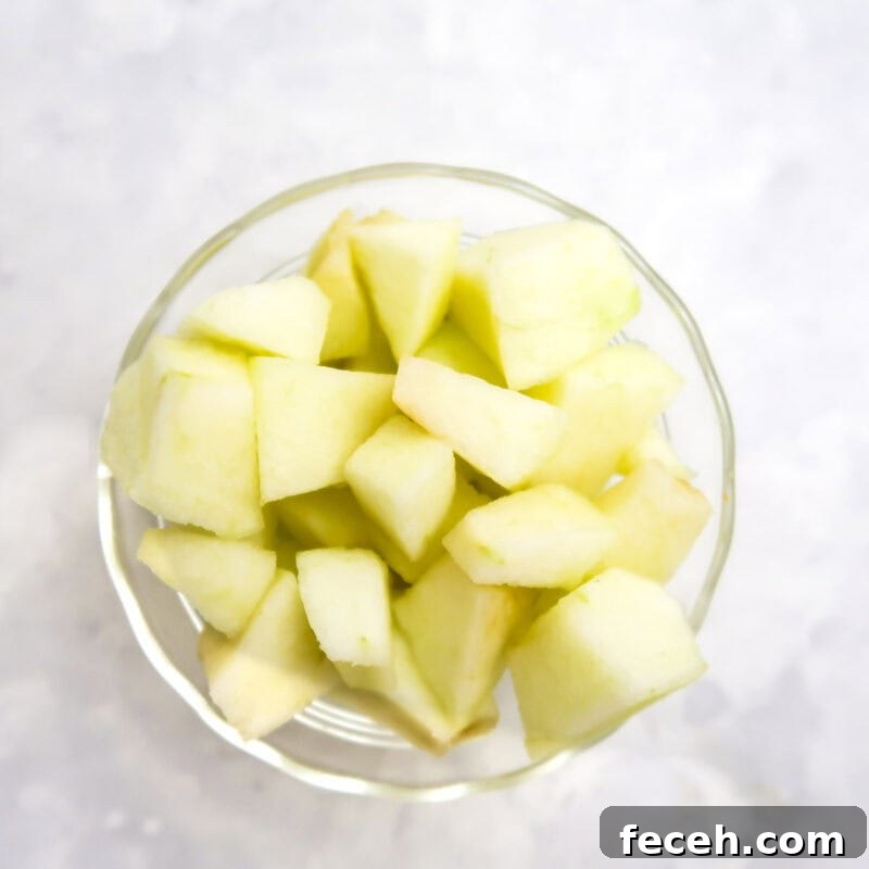 Overhead view of process shot 1 - chop the apple into small chunks.