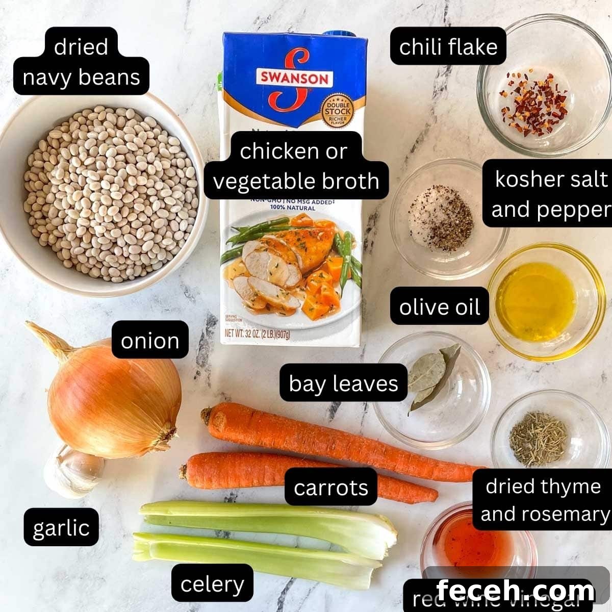 Instant Pot Navy Bean Soup Recipe for Creamy, Hearty Comfort 4 The labeled ingredients for Instant Pot Navy Bean Soup are shown on a white marble counter.