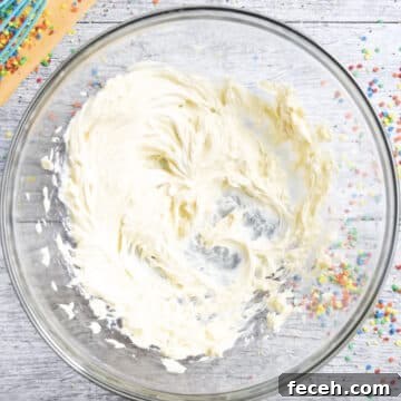 Creamed butter and vanilla in glass bowl.