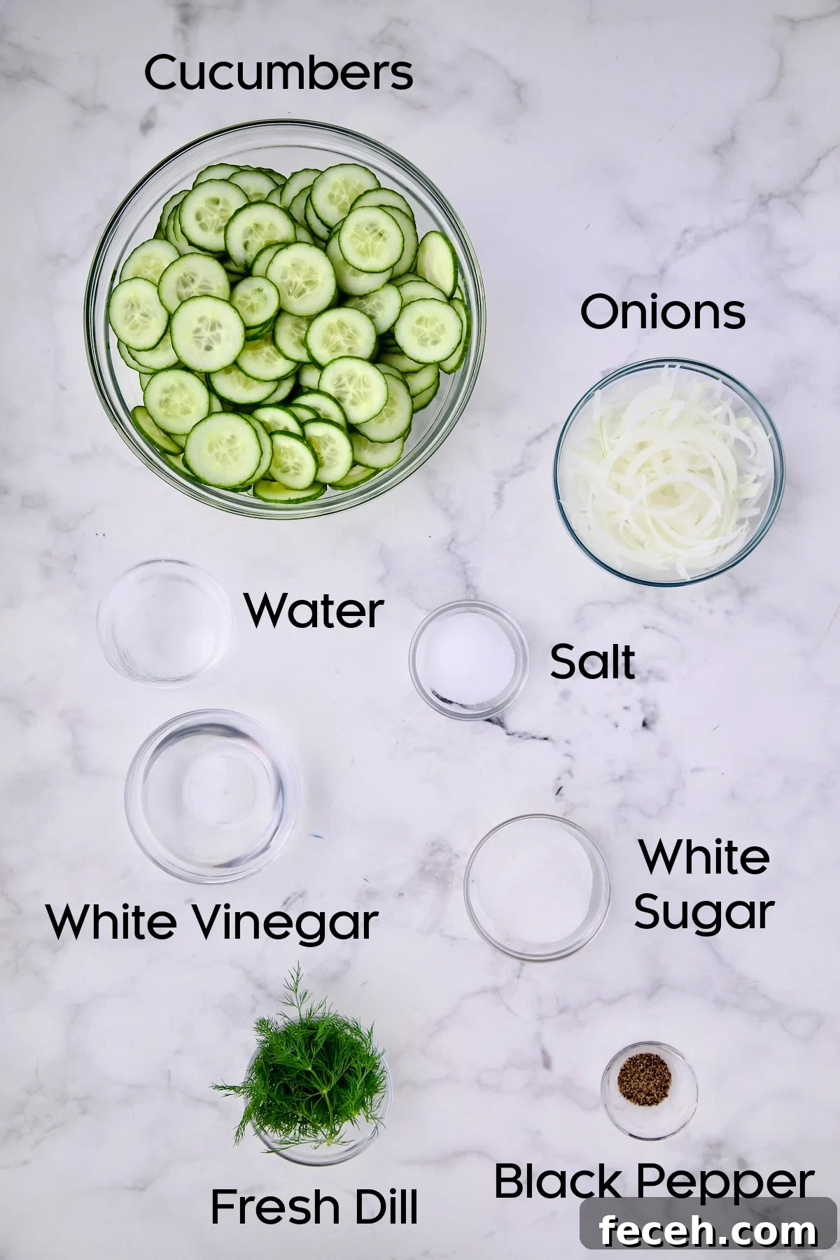 Ingredients for Cucumber Onion Salad in glass bowls.
