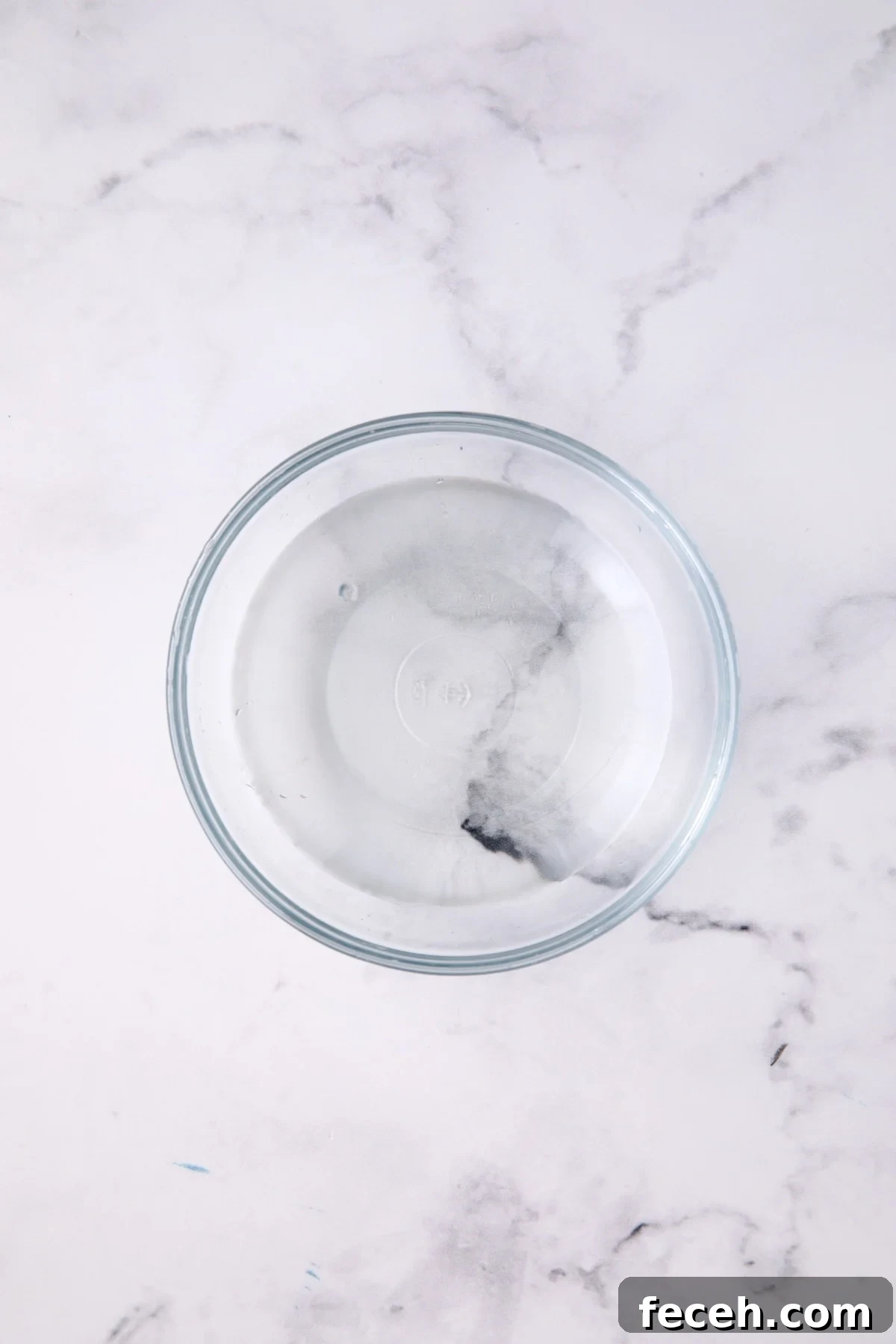 Vinegar, water and sugar dressing for salad in glass bowl.