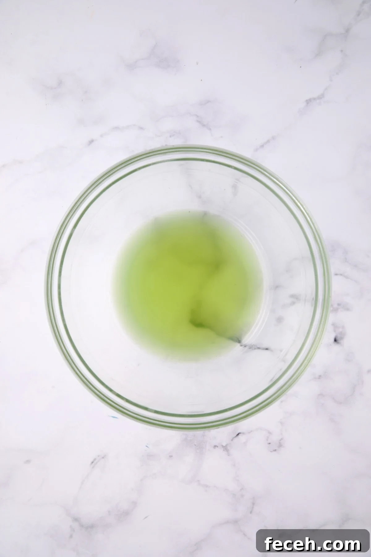Liquid from cucumbers in glass bowl.