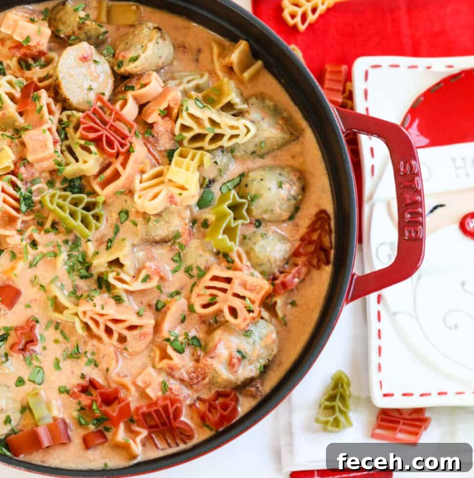 A large red cast iron pot filled with Christmas soup topped with holiday pasta.