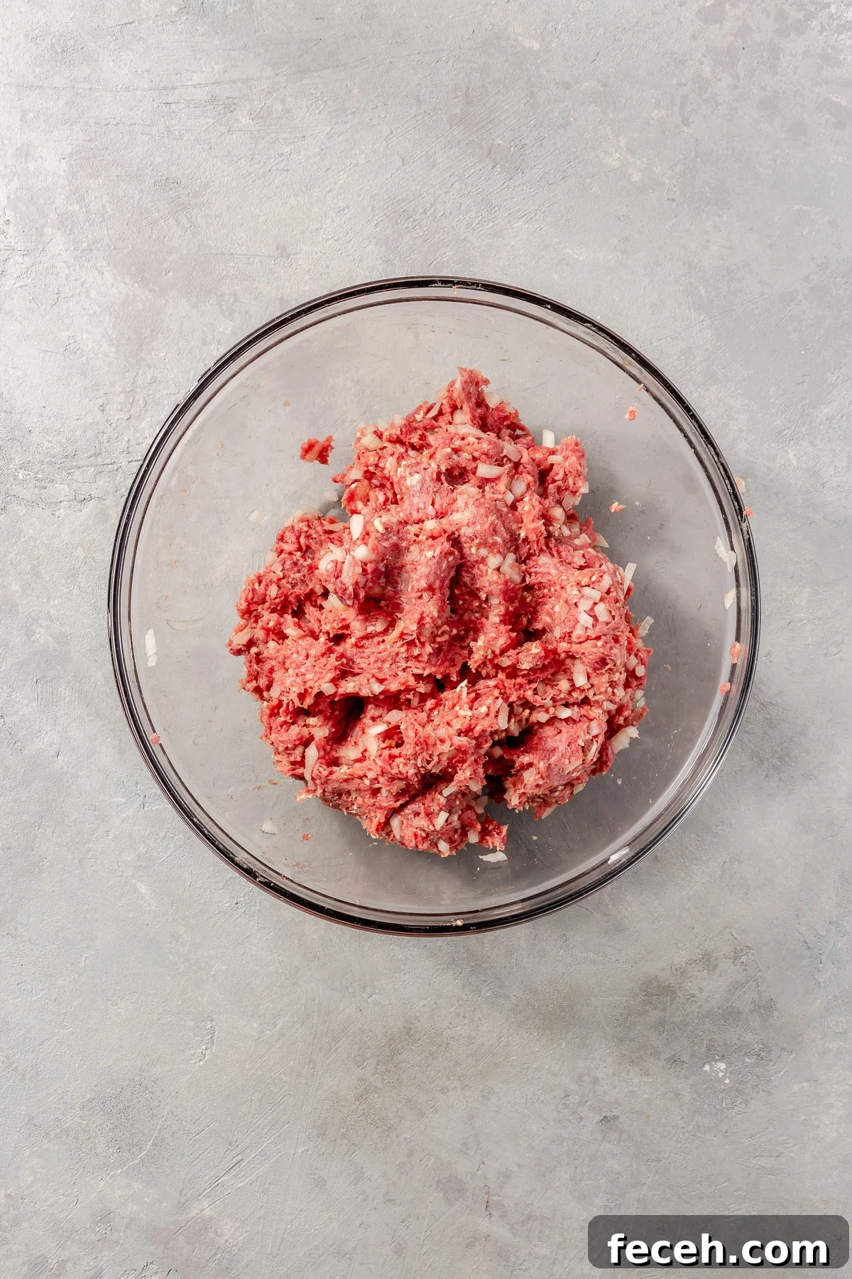 The ground beef and ingredients have been mixed together.