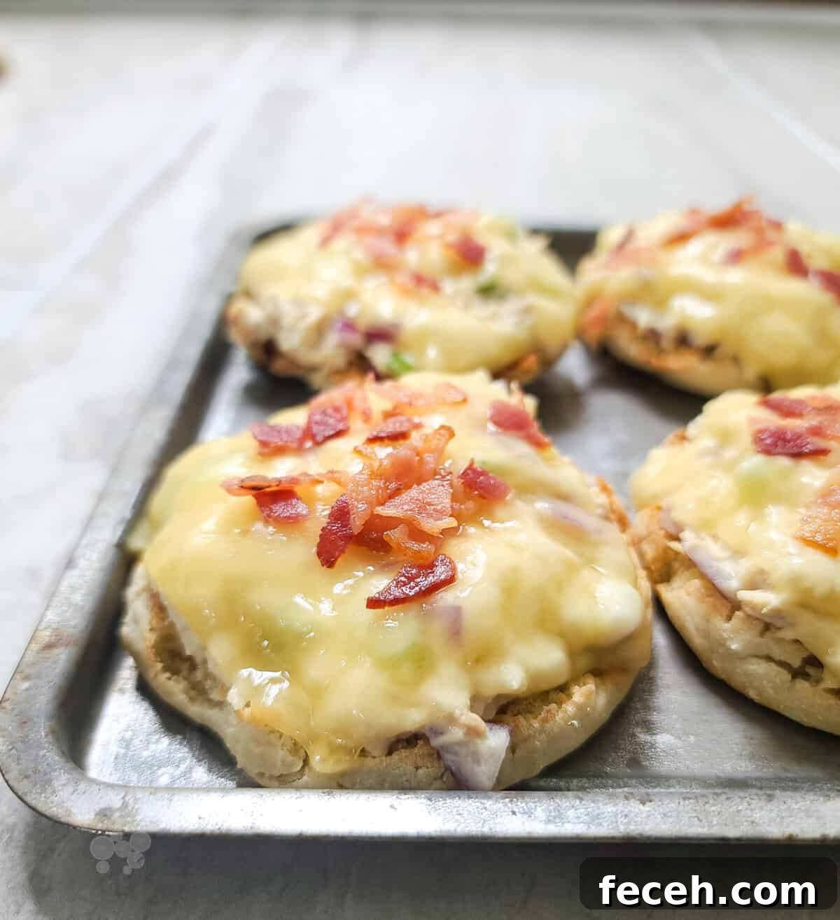 Bacon-Topped Open-Faced Tuna Melt Recipe 5 tuna melts on bake sheet topped with bacon