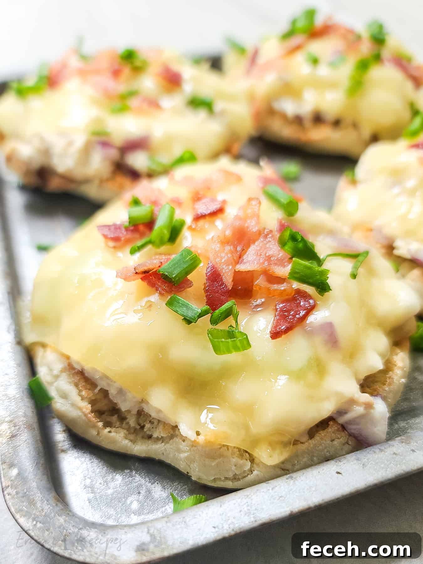 Bacon-Topped Open-Faced Tuna Melt Recipe 7 close, side view of open faced tuna melt on bake sheet topped with bacon and chives