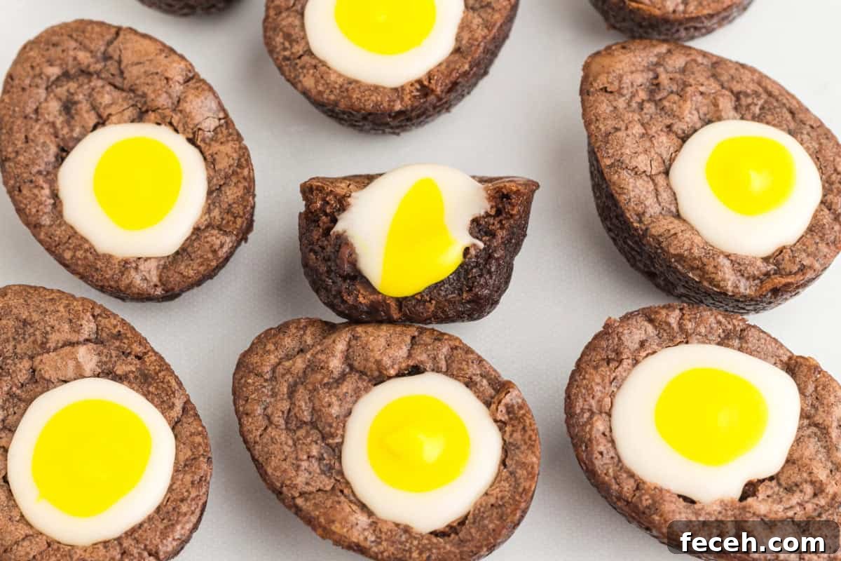 a halved and upturned creme egg brownie showing the filling surrounded by whole brownies.