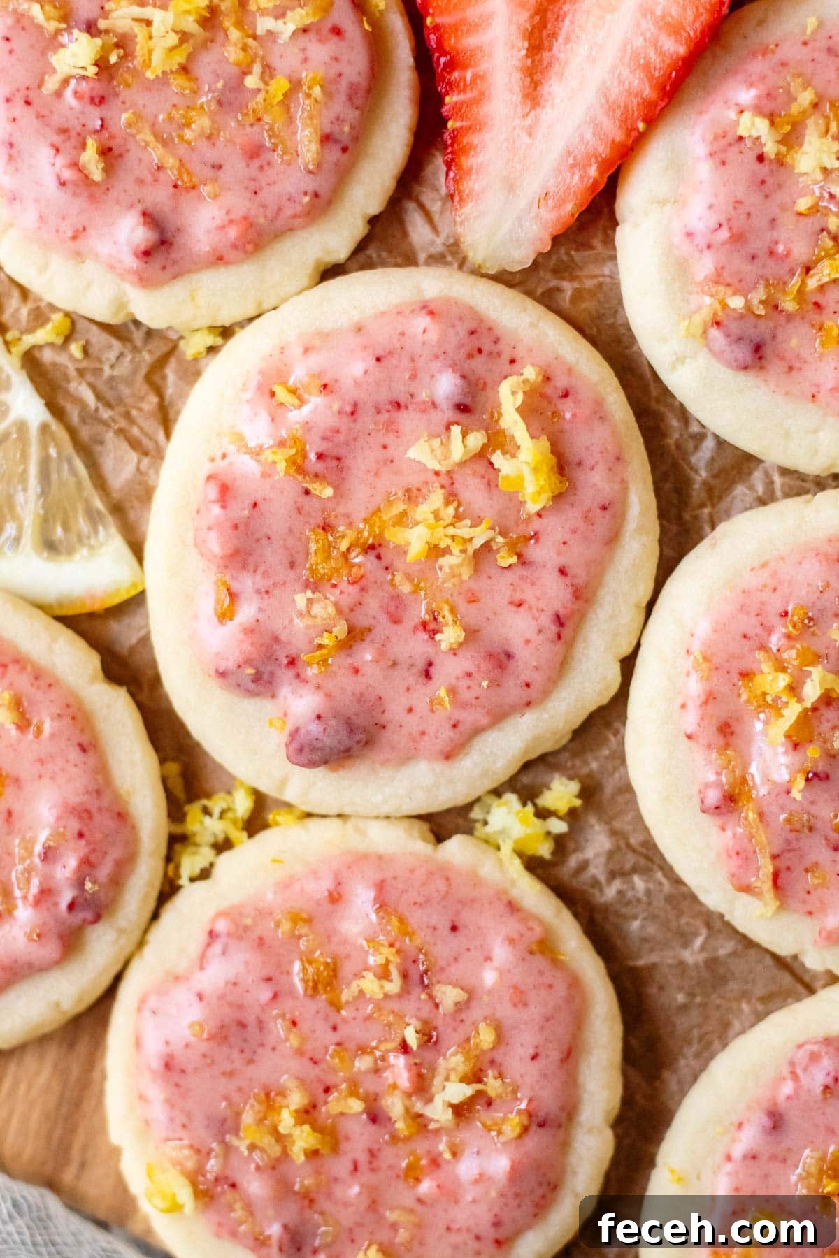 lemon shortbread cookies with strawberry glaze on parchment paper
