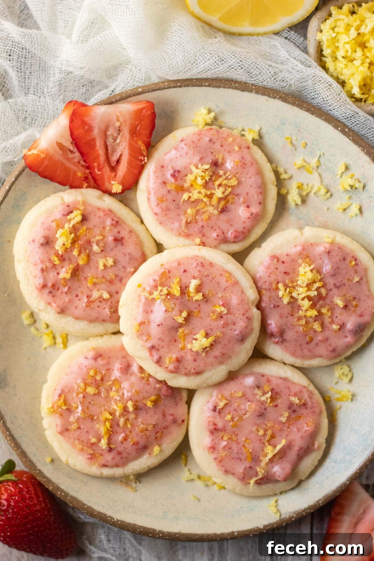 lemon shortbread cookies with strawberry glaze on a gray plate