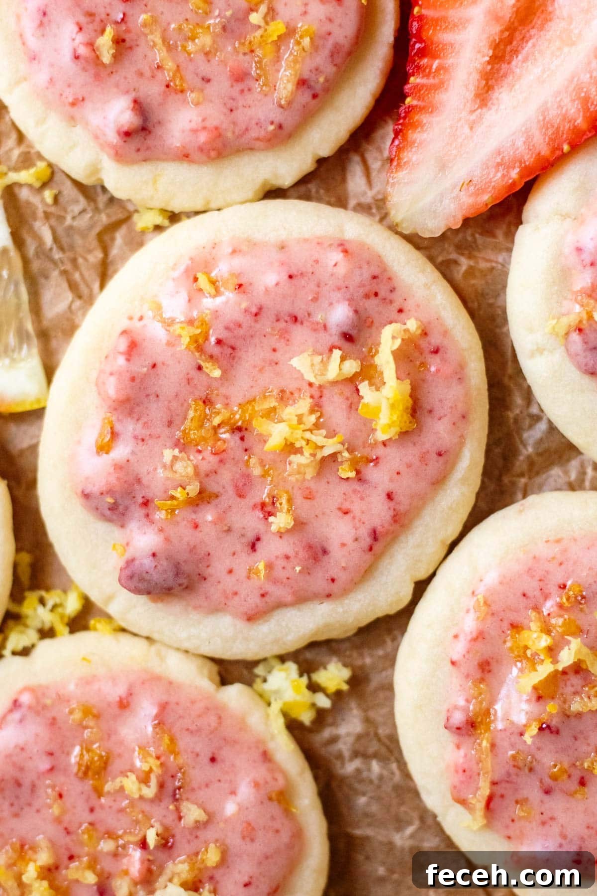 lemon shortbread cookies with strawberry glaze on parchment paper