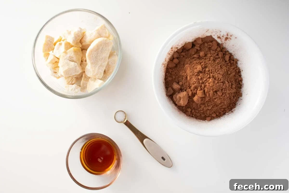 Homemade Dark Chocolate Bar Recipe: Rich, Smooth, & Simple 3 Cacao butter, cocoa powder, maple syrup and salt on a counter