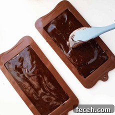 Homemade Dark Chocolate Bar Recipe: Rich, Smooth, & Simple 4 Two silicone chocolate bar molds with melted chocolate in them