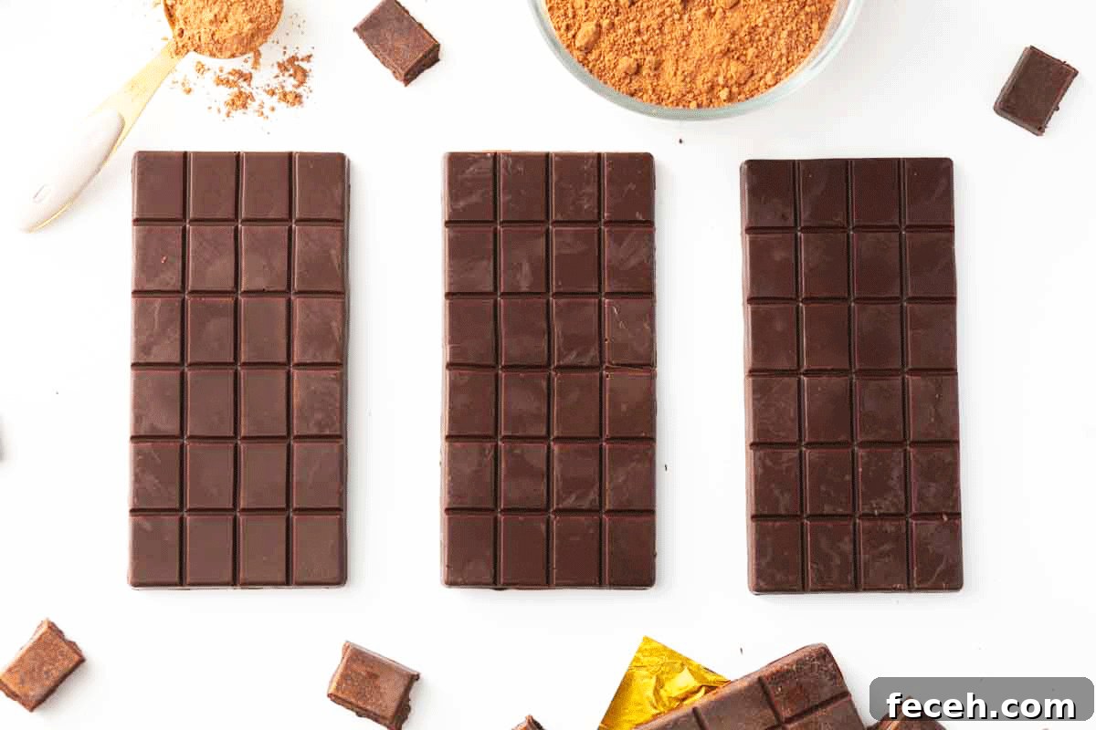 Homemade Dark Chocolate Bar Recipe: Rich, Smooth, & Simple 8 Three chocolate bars, a bowl of cocoa powder and gold foil on a counter