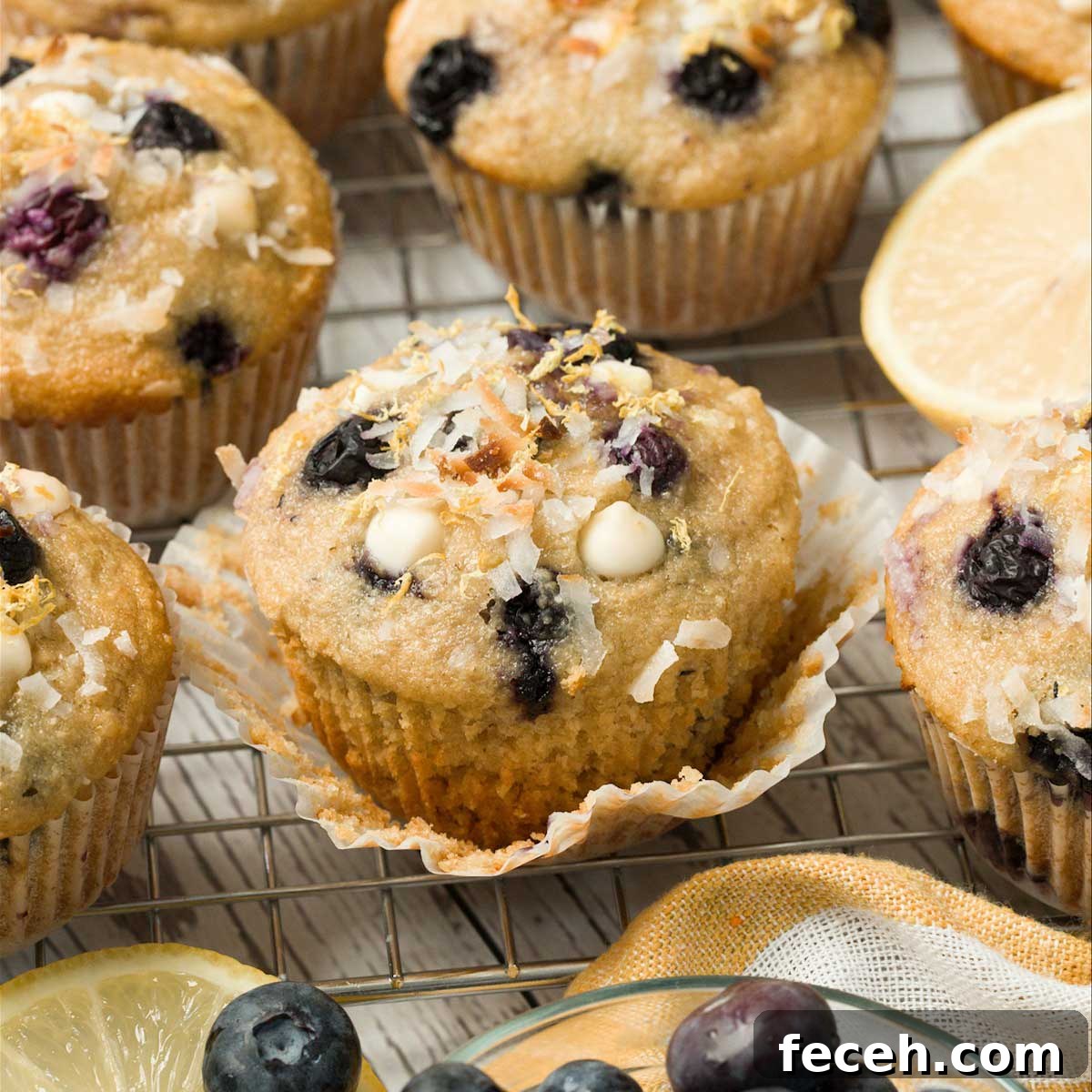 Peach Banana Smoothie Bowl topped with Vanilla Almond Granola 11 Gluten-Free Blueberry Lemon Muffins on a cooling rack.