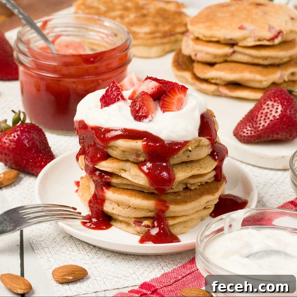 Peach Banana Smoothie Bowl topped with Vanilla Almond Granola 12 Stack of gluten-free strawberry pancakes on a plate.