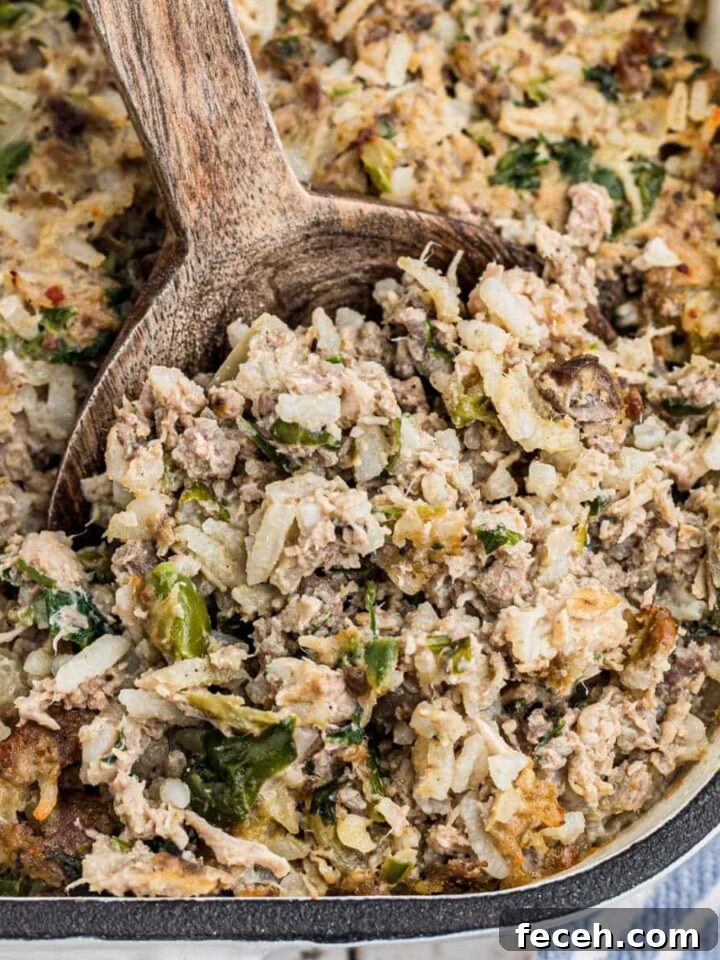 Close up of the corner of a casserole dish of Cajun rice dressing.