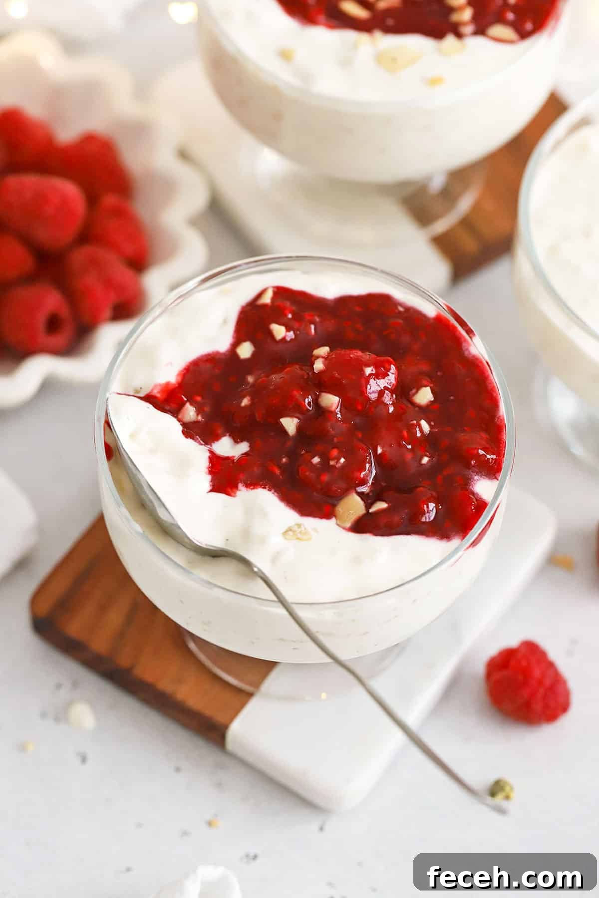 Danish rice pudding in dessert bowls topped with raspberry sauce