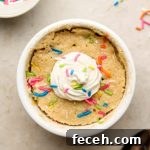 vanilla cake with sprinkles in a bowl with cream on top