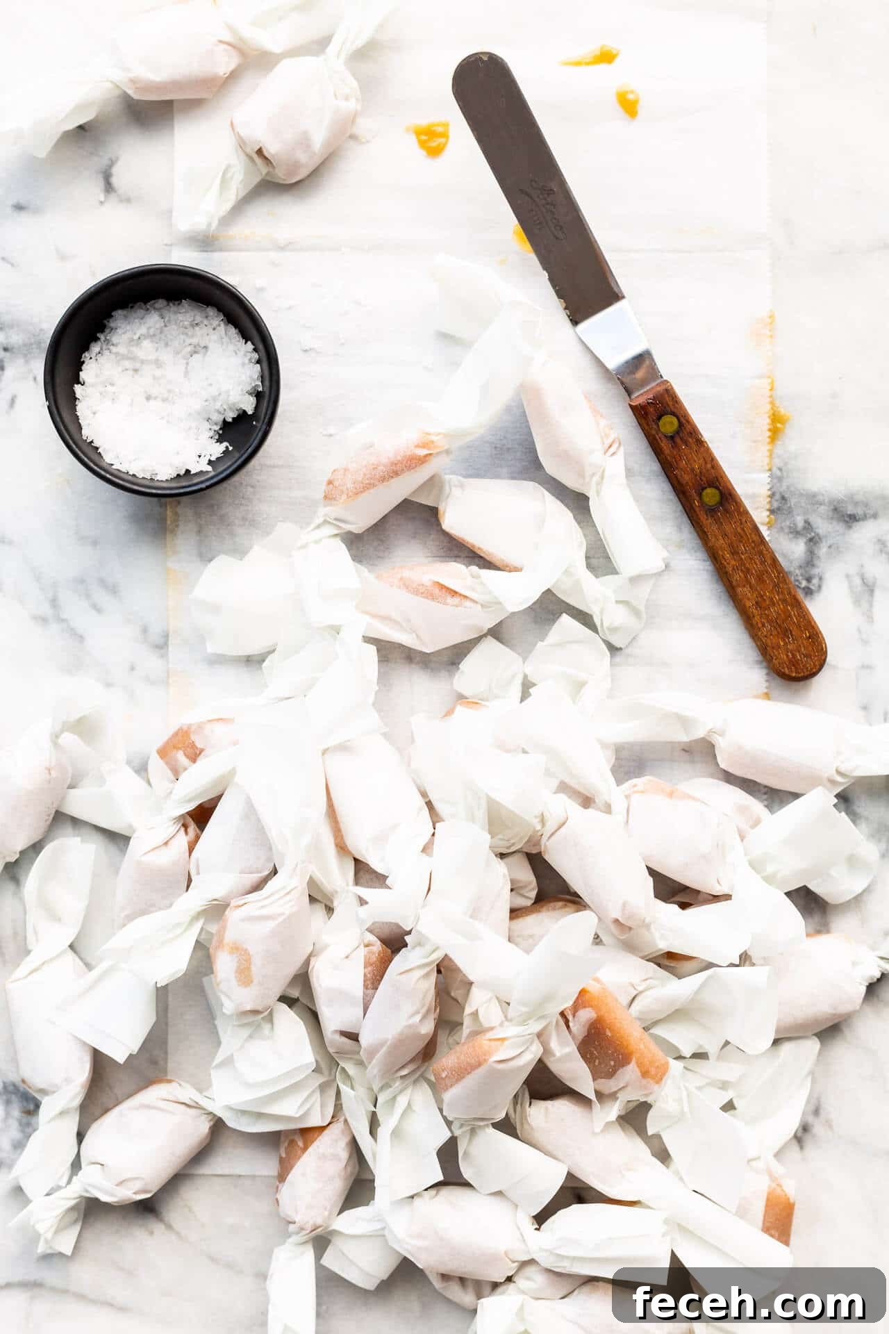 Homemade salted caramels all wrapped un in parchment paper