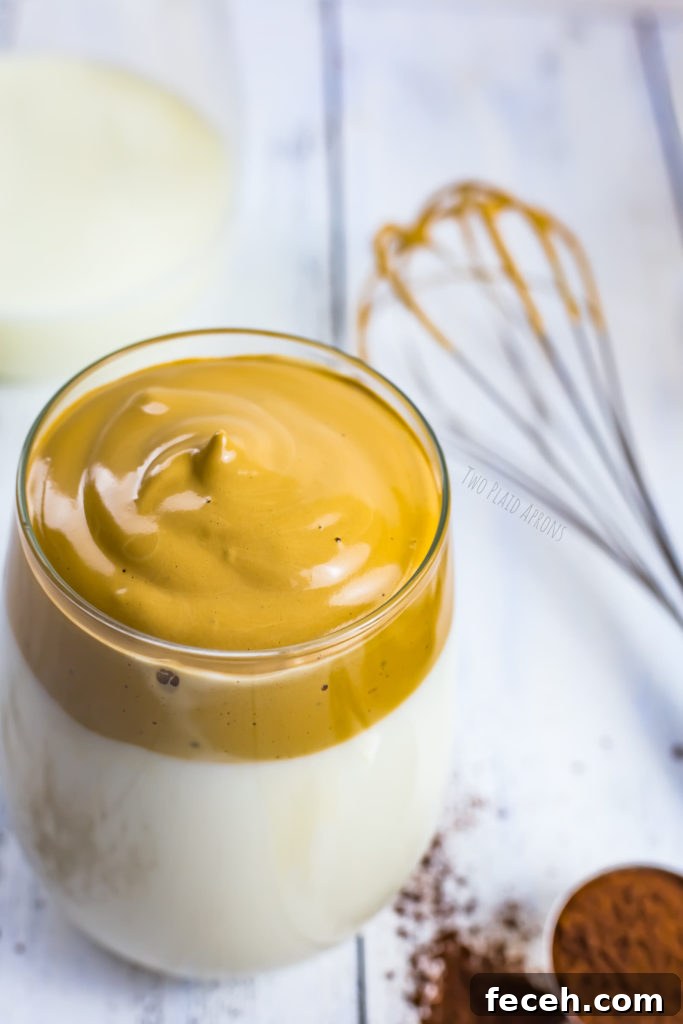 Milk topped with whipped Dalgona coffee.
