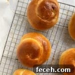 Challah rolls on a cooling rack.