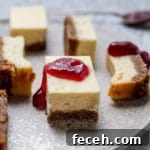 Close up of a cheesecake bar with jam on it.