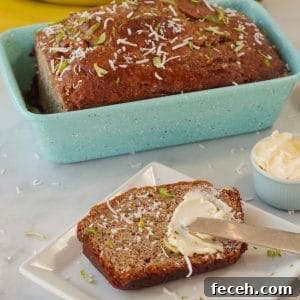 banana bread in blue loaf pan with slice of banana bread on a white plate with butter