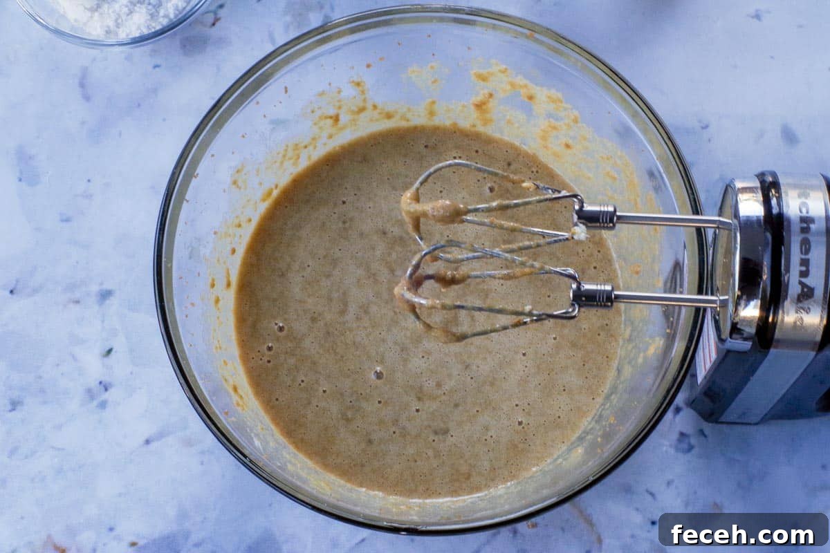 Wet ingredients added to butter/sugar mixture and beaten together in large glass bowl with beaters.