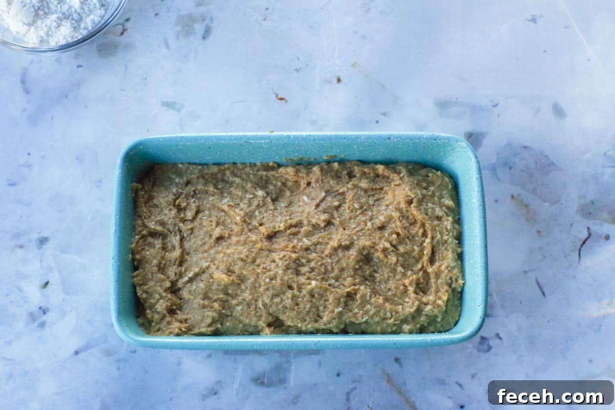 Tropical Banana Bread batter poured into a blue loaf pan.