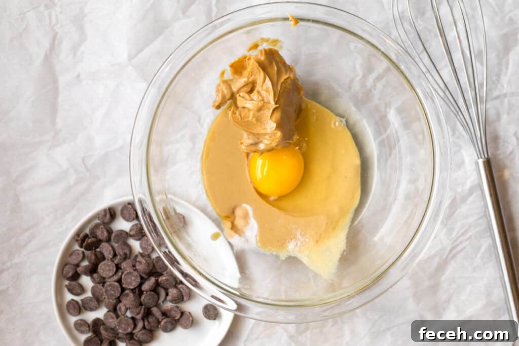 egg, peanut butter, tahini, maple syrup and baking soda in a glass bowl