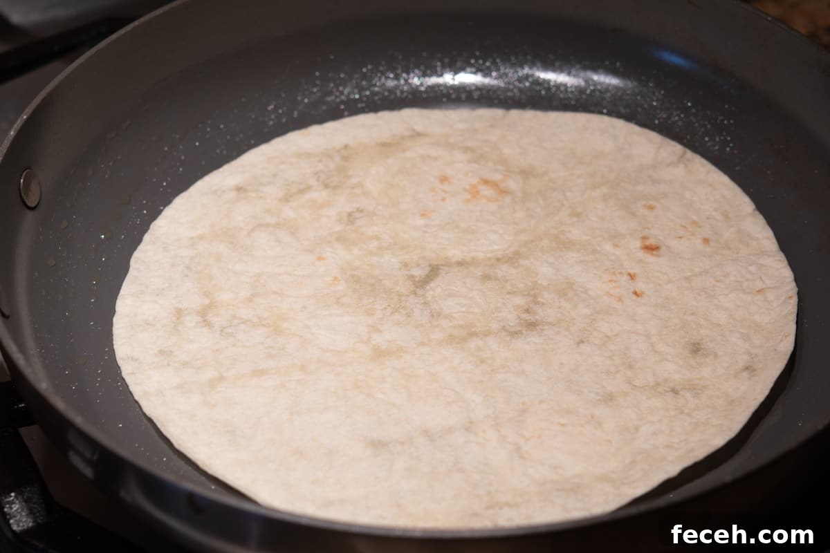 lightly browning flour tortilla in skillet.