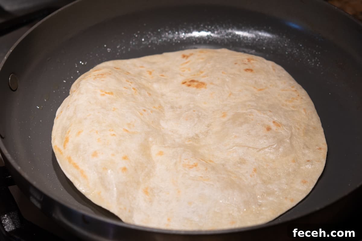 browned flour tortilla in skillet.